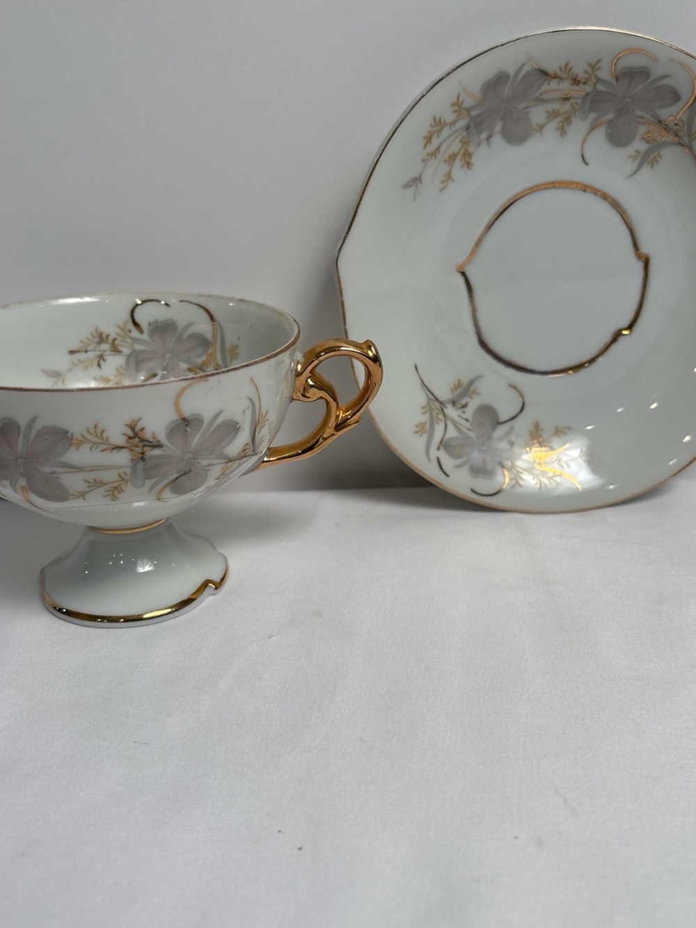 Elegant White Porcelain Teacup and Saucer with Gold Trim